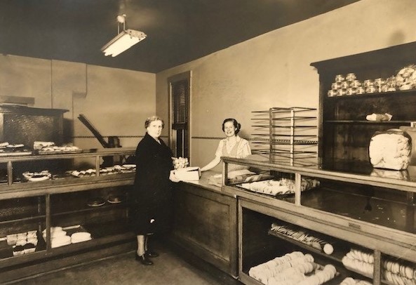 A woman standing in front of a counter.