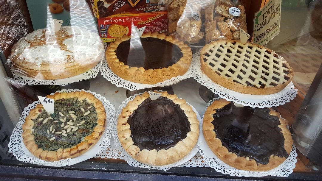 A variety of pies on display in a store.