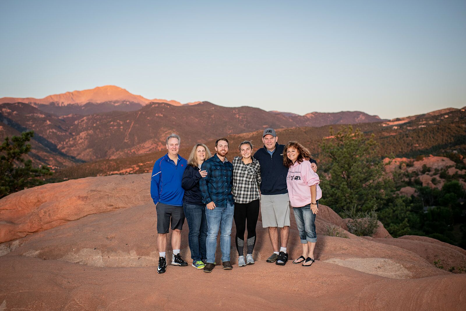 A group of people standing on top of a hill.