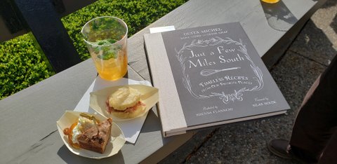 A book sitting on top of a table next to some food.