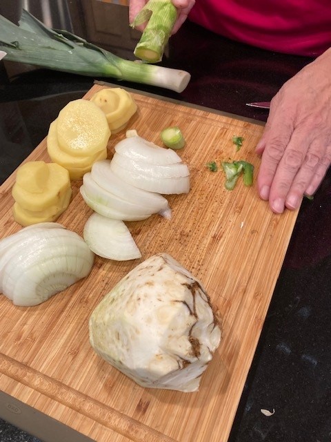 A person is cutting up onions on a board