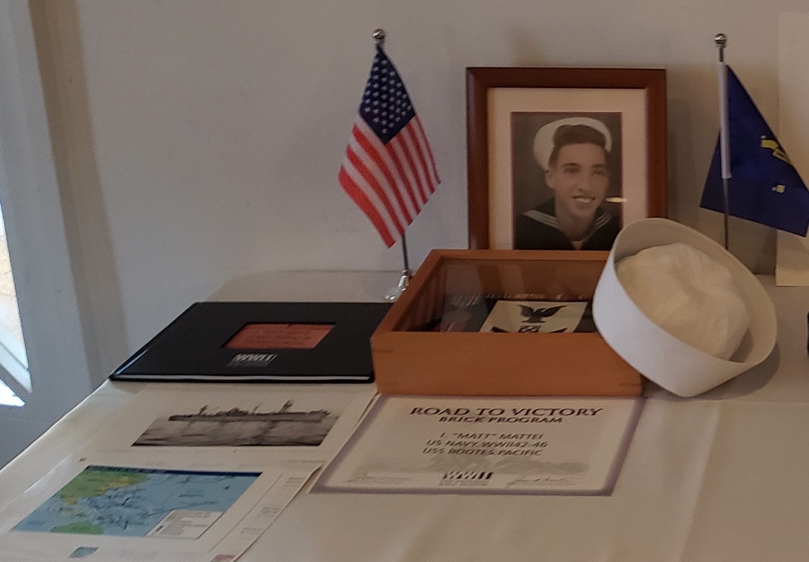 A table with an american flag and a picture of a man.