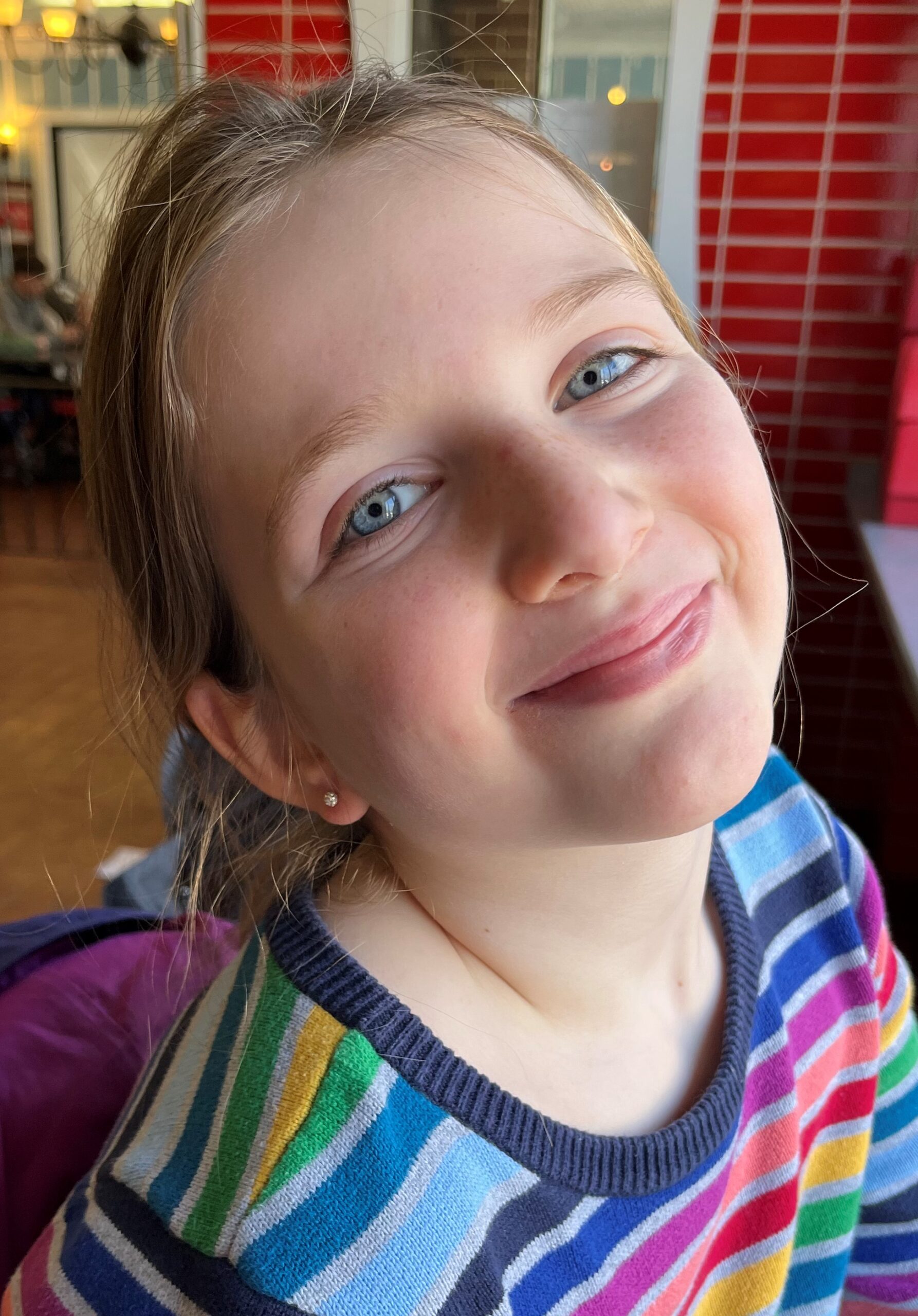 A young girl smiling for the camera.