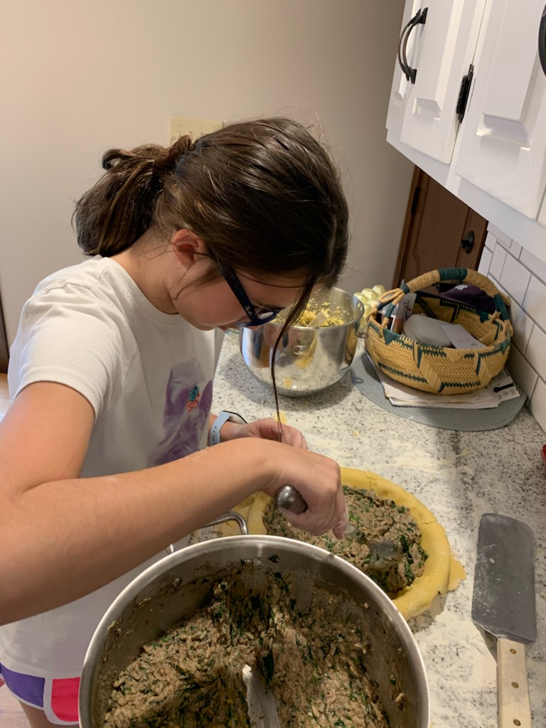 A woman is making food in the kitchen.