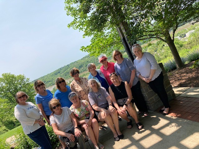 P8 A group of people standing on top of a bench.