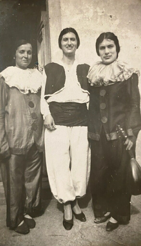 A man and two women dressed as clowns.