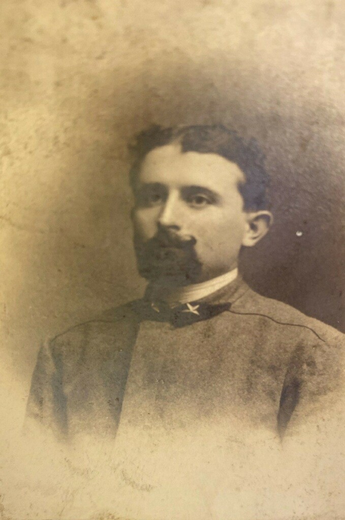 A man with a beard and mustache in an old photo.