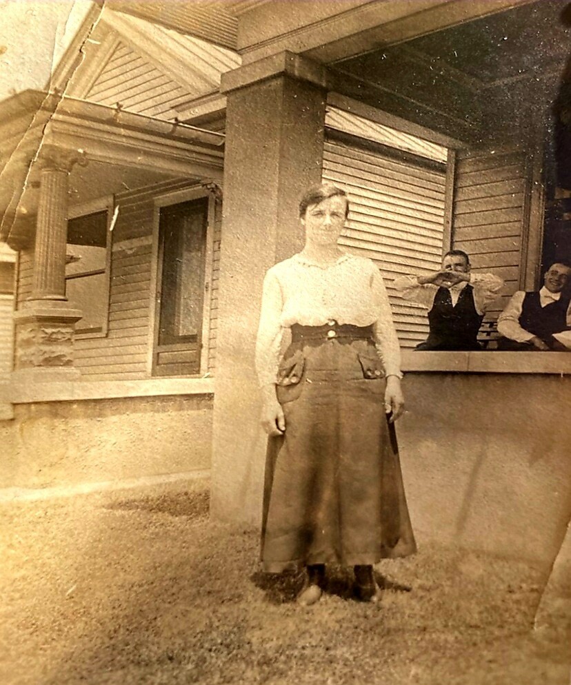 A woman standing in front of some people.