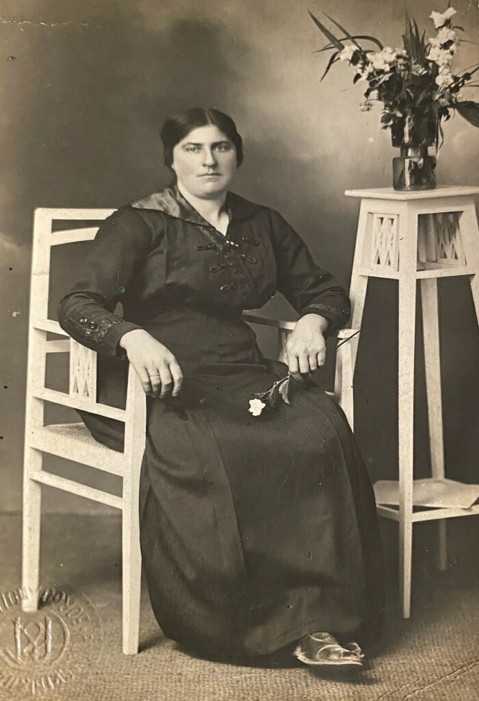 A woman sitting in a chair with her legs crossed.