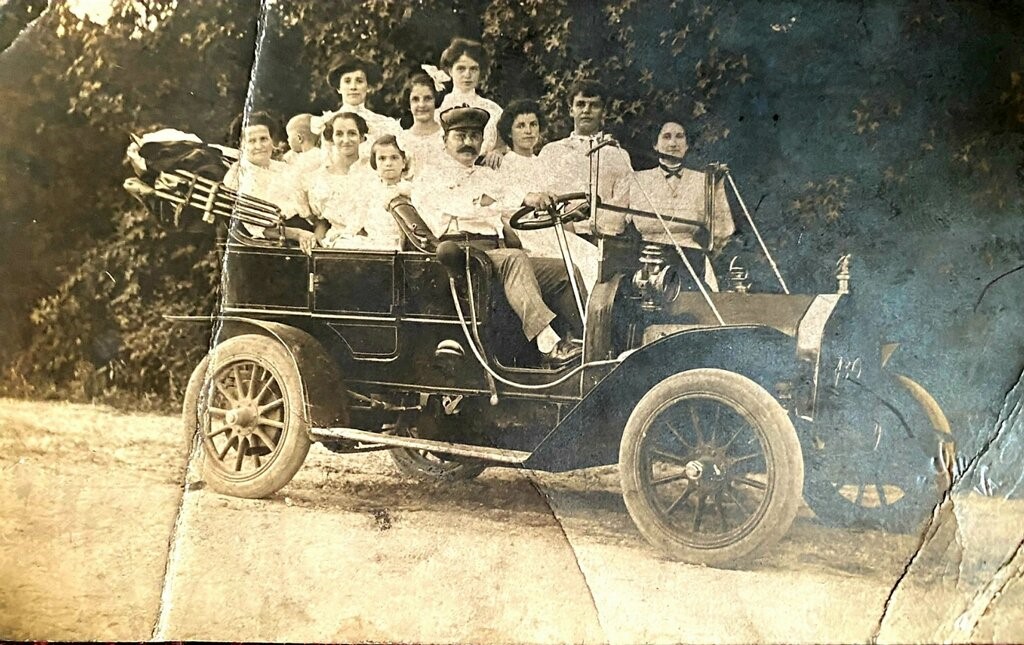 A group of people in an old car.