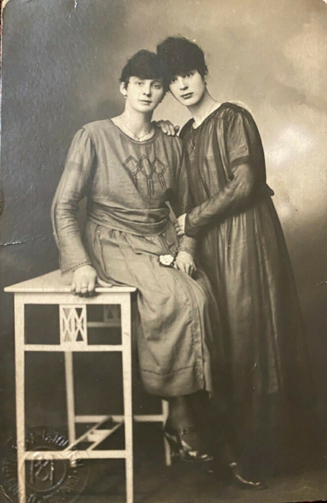 Two women in old photos posing for a picture.