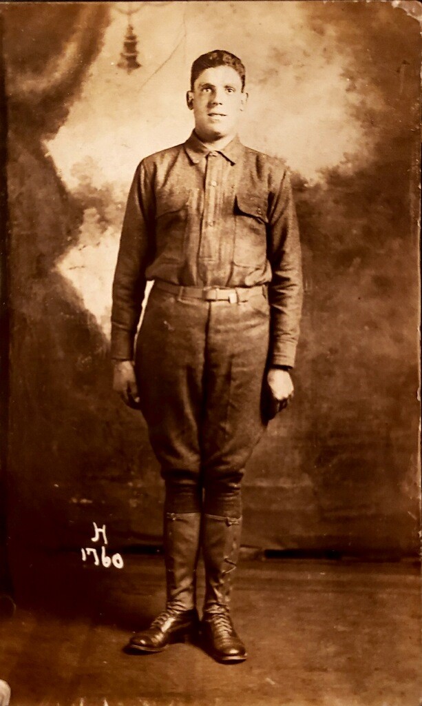 A man in uniform standing on top of a wall.