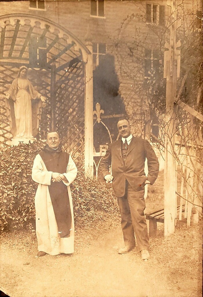 A man and woman standing in front of a tree.