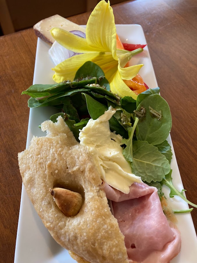 A plate of food with bread and salad on it.