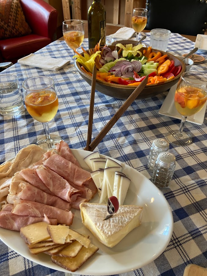 A table with plates of food and glasses on it