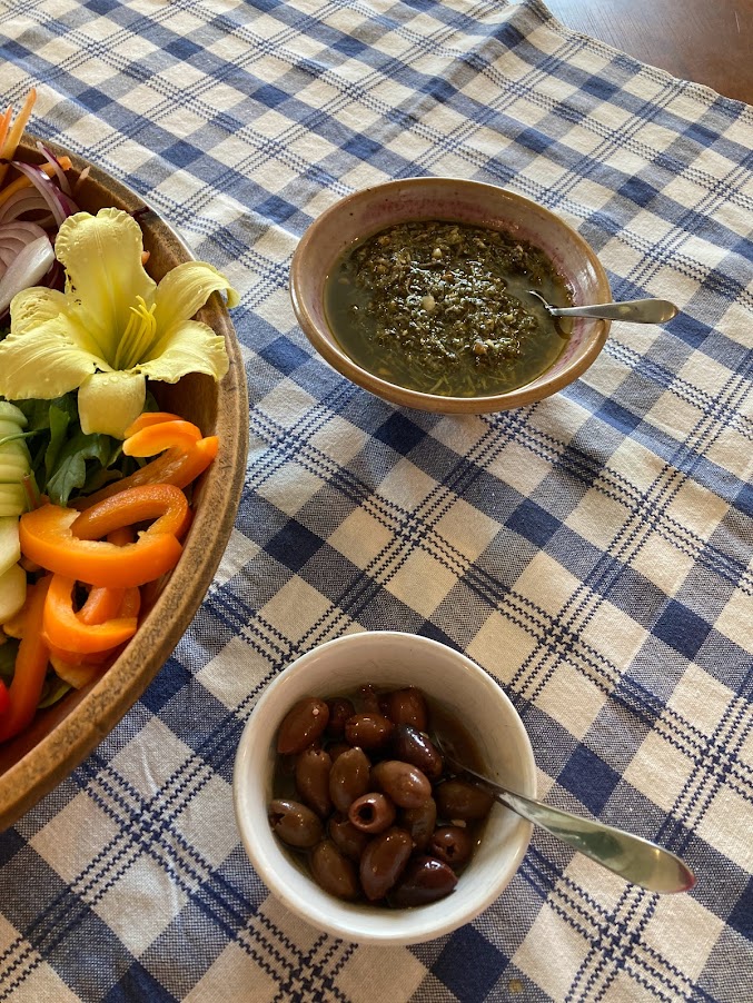 A table with bowls of food and salad.