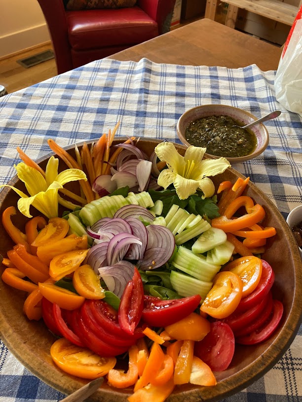 A wooden bowl of vegetables on the table