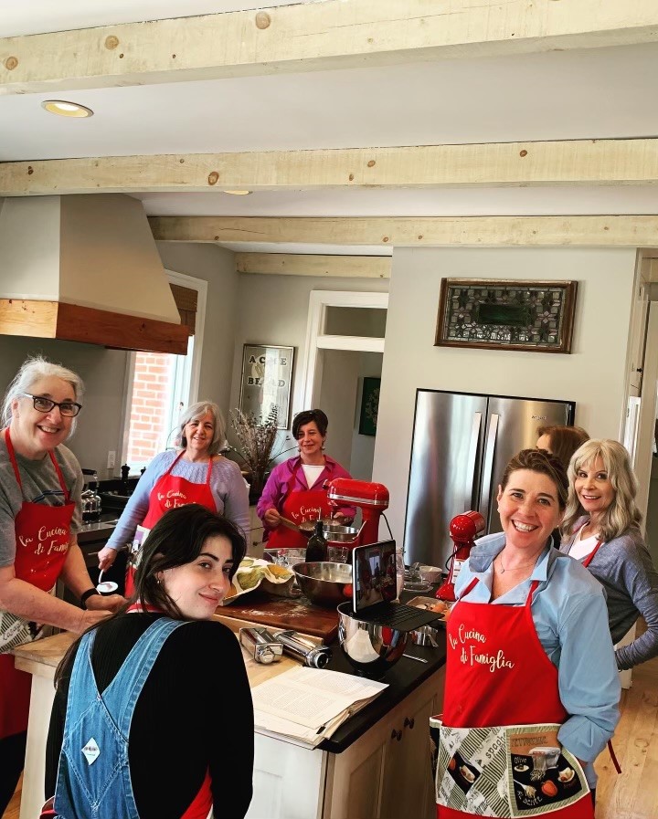 A group of people in aprons preparing food.