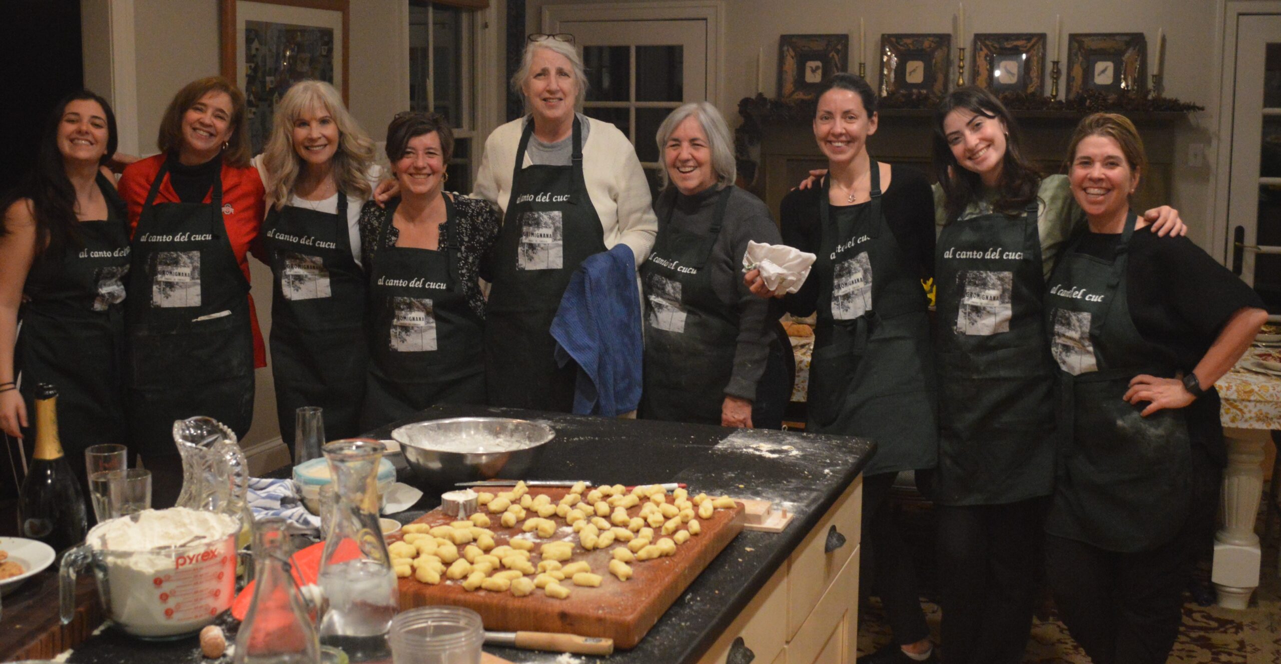 A group of people standing in front of an oven.